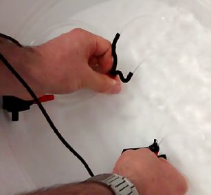 Testing 3D printed nozzles in a bucket of water.