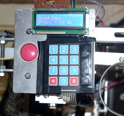 Control panel on top of the robot, with a character display, keypad, and emergency stop button.